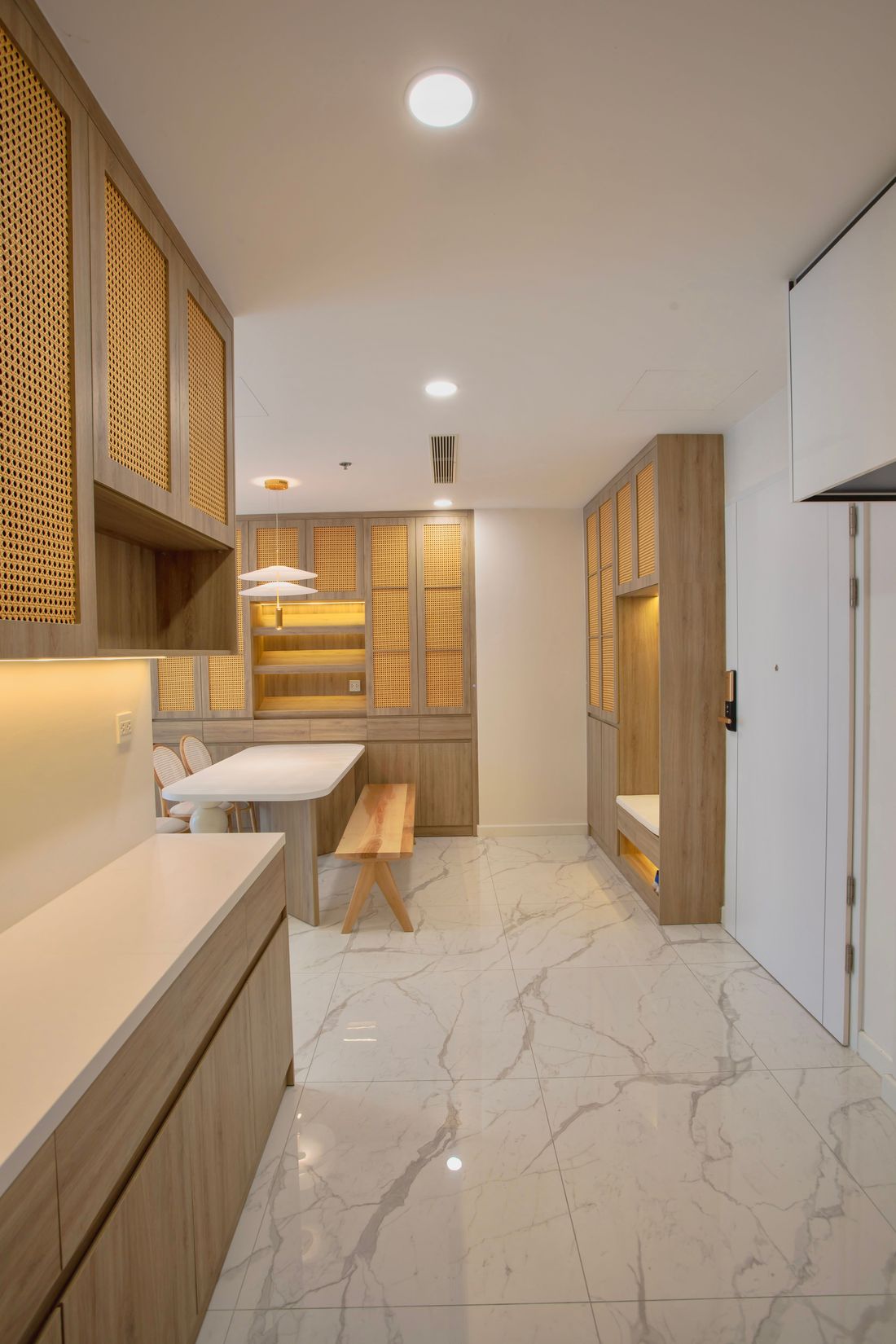 Built-in cabinets with cane doors and an entry bench